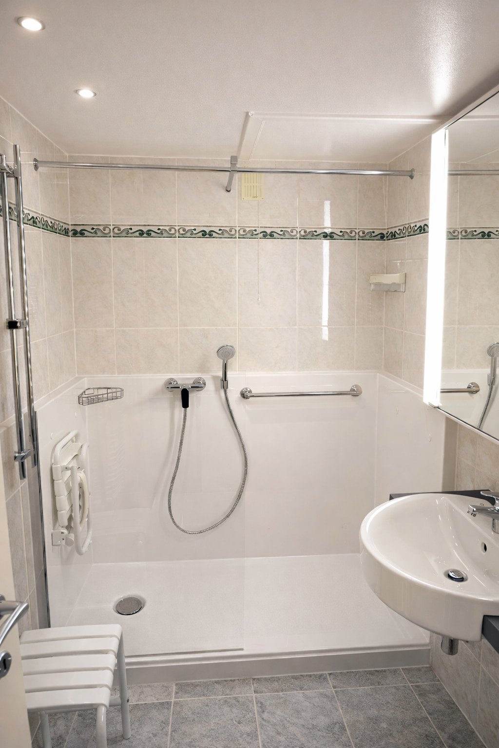 modern walk-in shower with high-end marble finish and glass door in a luxury Belgian home